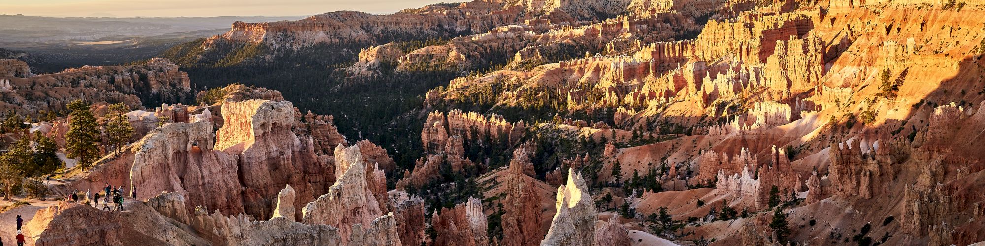 The image features a panoramic view of Bryce Canyon National Park, showcasing its distinctive red rock formations and spires known as hoodoos.